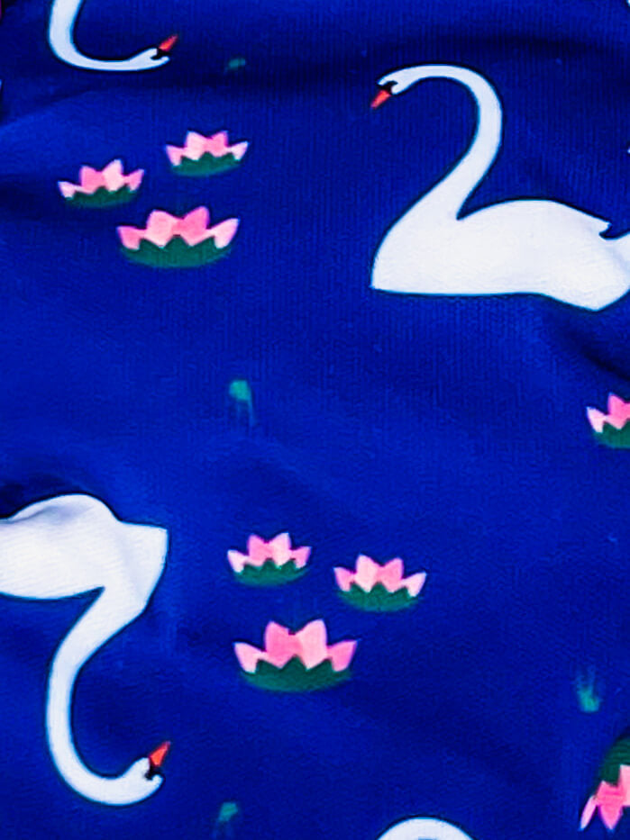 Close up of the digital printed PUL diaper shell with blue background, swans and pink flowers. 