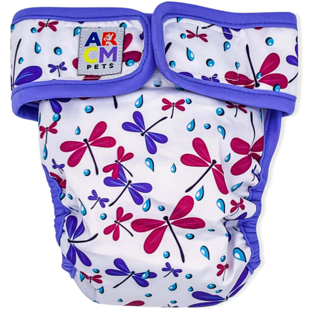 Free Spirit Cheekies are dog diapers. They are white with fuchsia dragonflies, purple dragonflies, blue rain drops and purple binding. (front) 